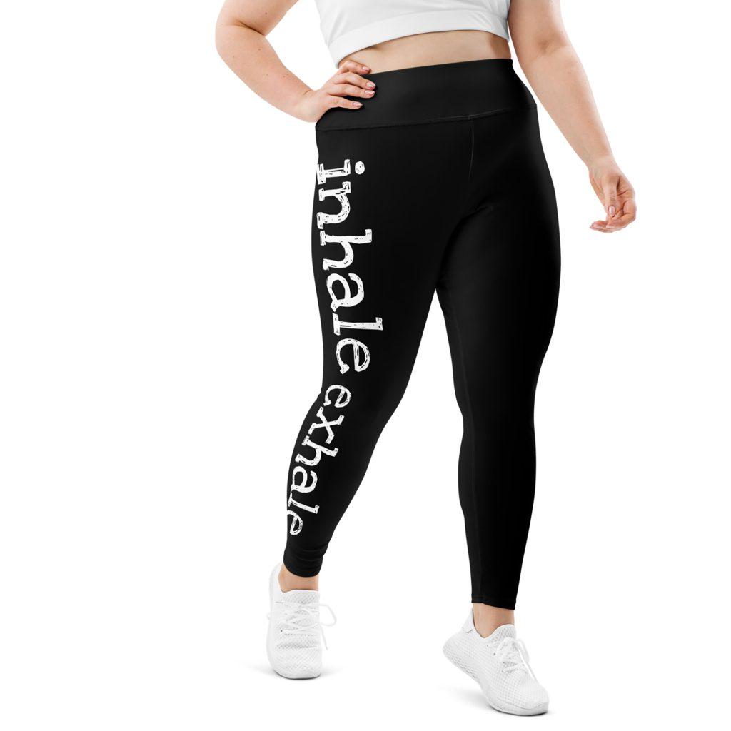 Lower part of a woman with plus size leggings with text Inhale Exhale on the leg