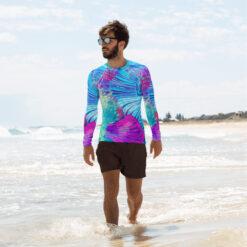 A man walking in the water wearing Ayanna rash guard for men from Mantaraj